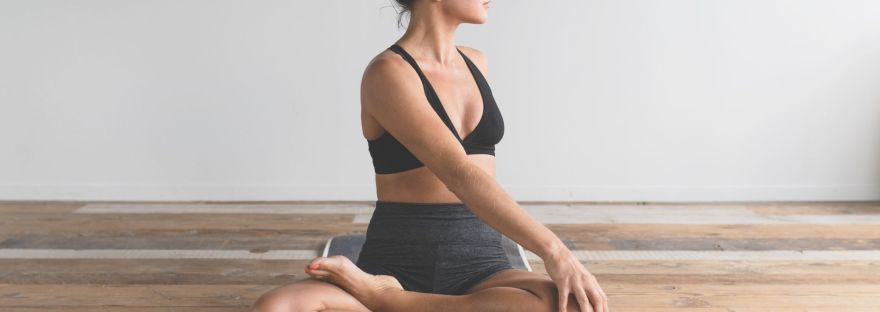 woman sitting on floor stretching and feeling clam