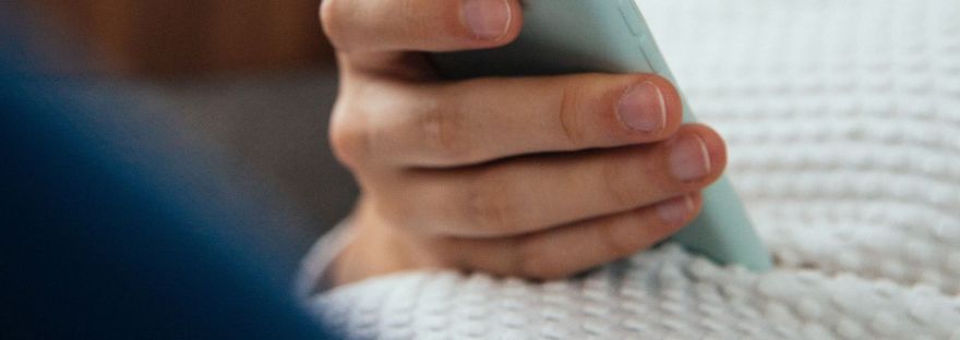 pregnant woman researching postpartum life on her phone